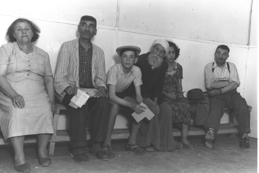 Immigrants from Iraq, Poland and Romania wait for medical examinations at the Atlit transit camp in northern Israel in summer 1951 (Teddy Brauner, GPO)