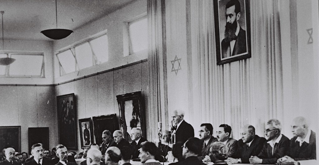 David Ben-Gurion, flanked by the members of his provisional government, reads the Declaration of Independence in the Tel Aviv Museum Hall on May 14, 1948 (photo credit: Israel Government Press Office)