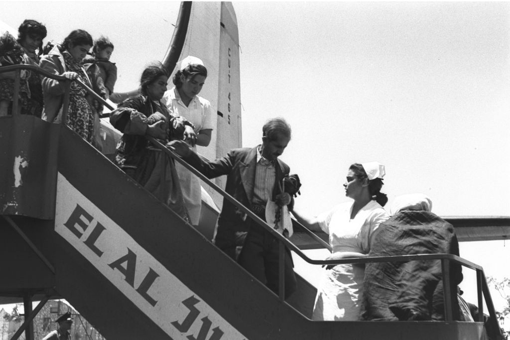 Immigrants from Iraq and Kurdistan exit their plane on arrival in Israel, having flown via Tehran, late spring 1951. (Teddy Brauner, GPO)