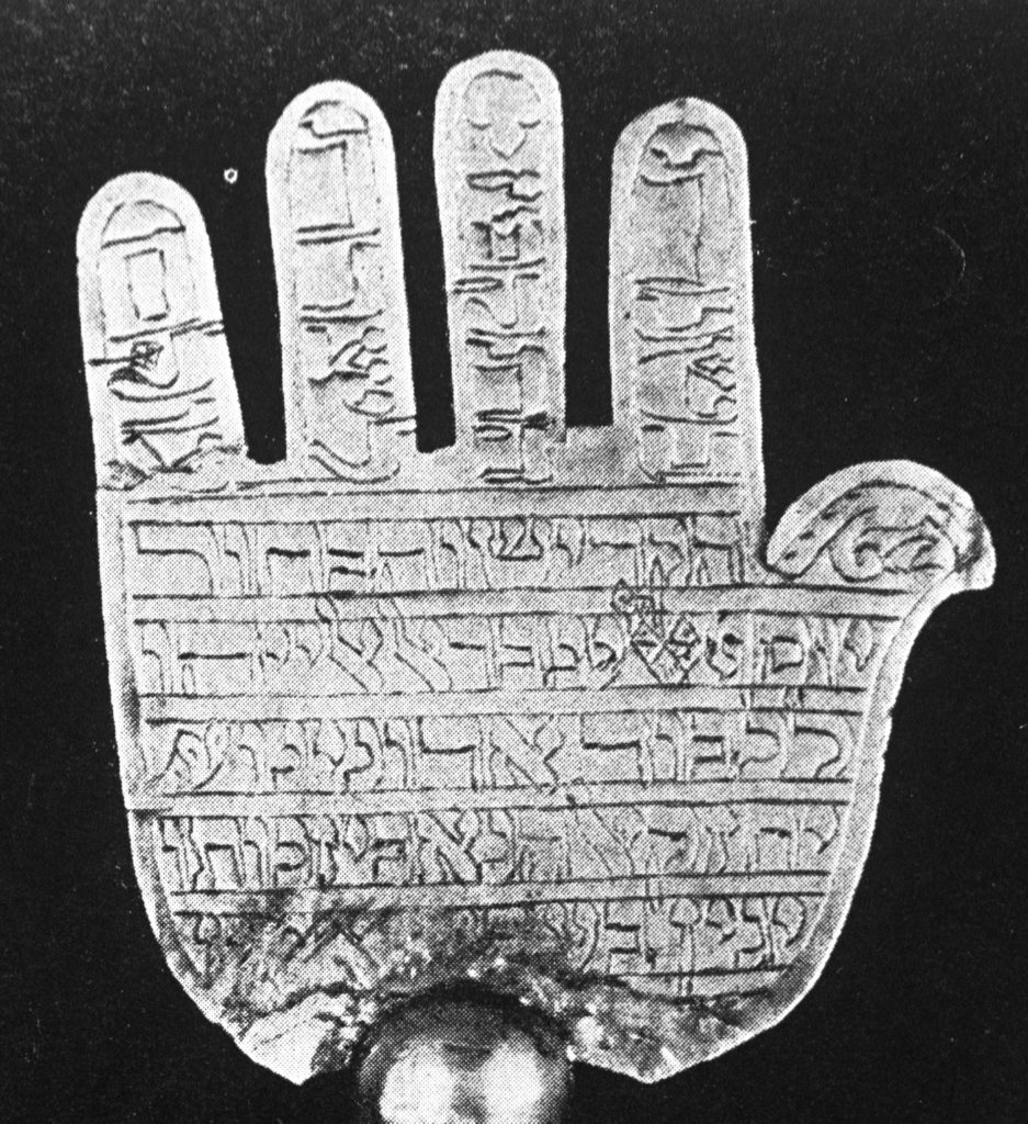 B&W image of a hand with written inscription on it